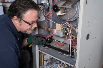 service-man-adjusting-house-heating-system